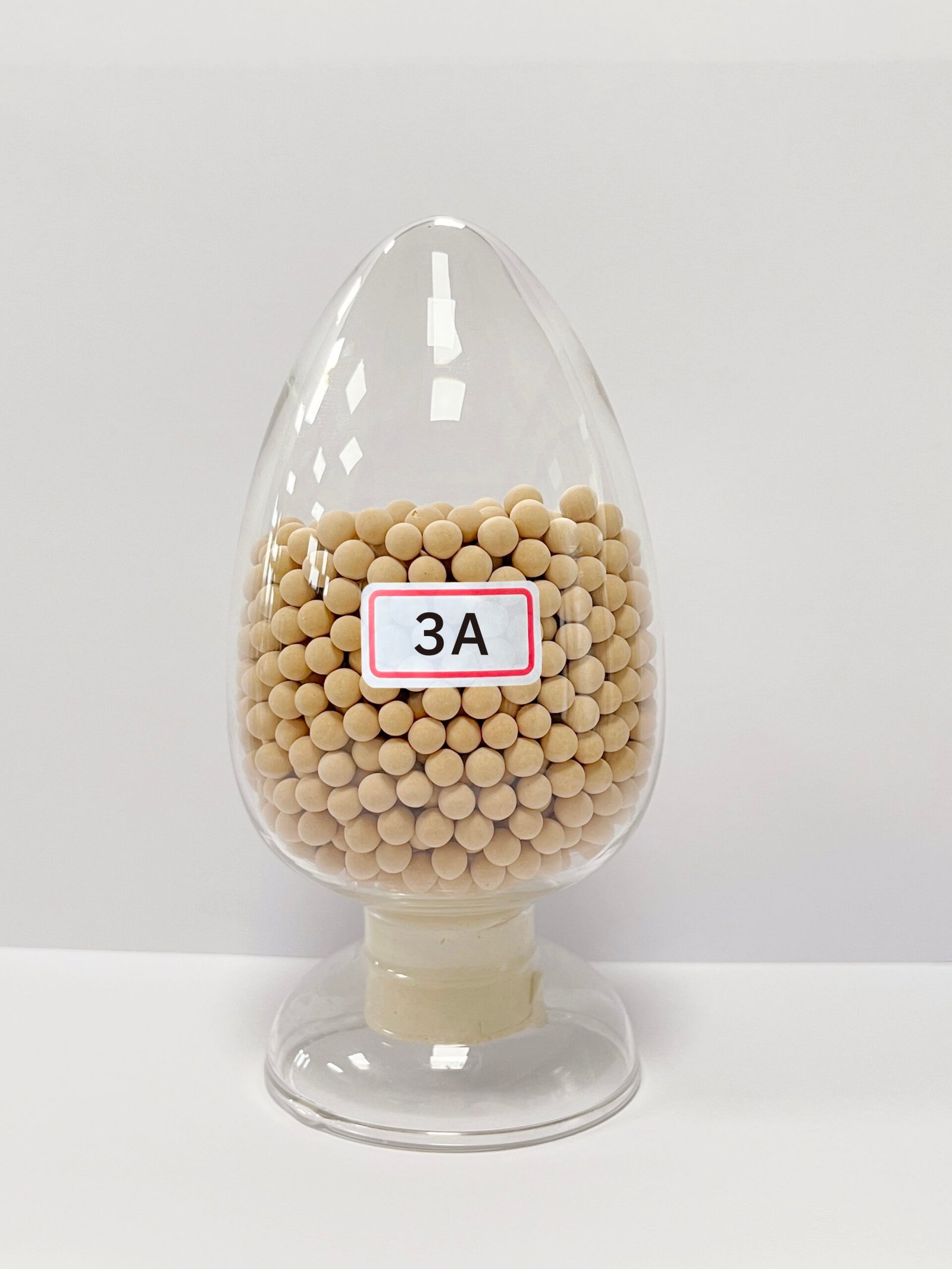 A close-up of 3A molecular sieve beads in a container