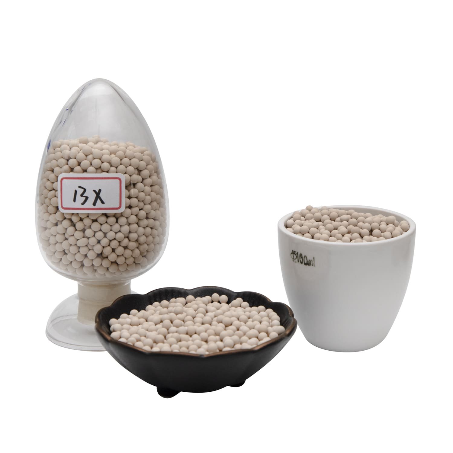 A close-up of molecular sieve beads being carefully loaded into an industrial vessel.