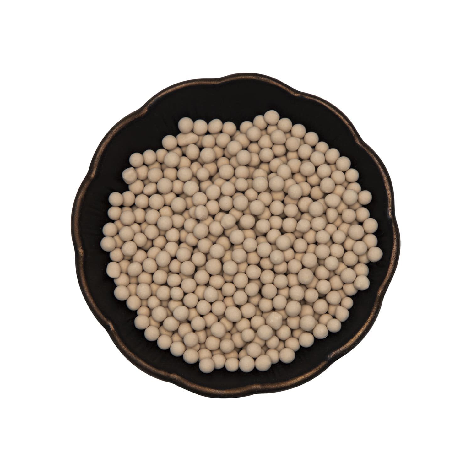 A worker carefully loading molecular sieves into an industrial tower