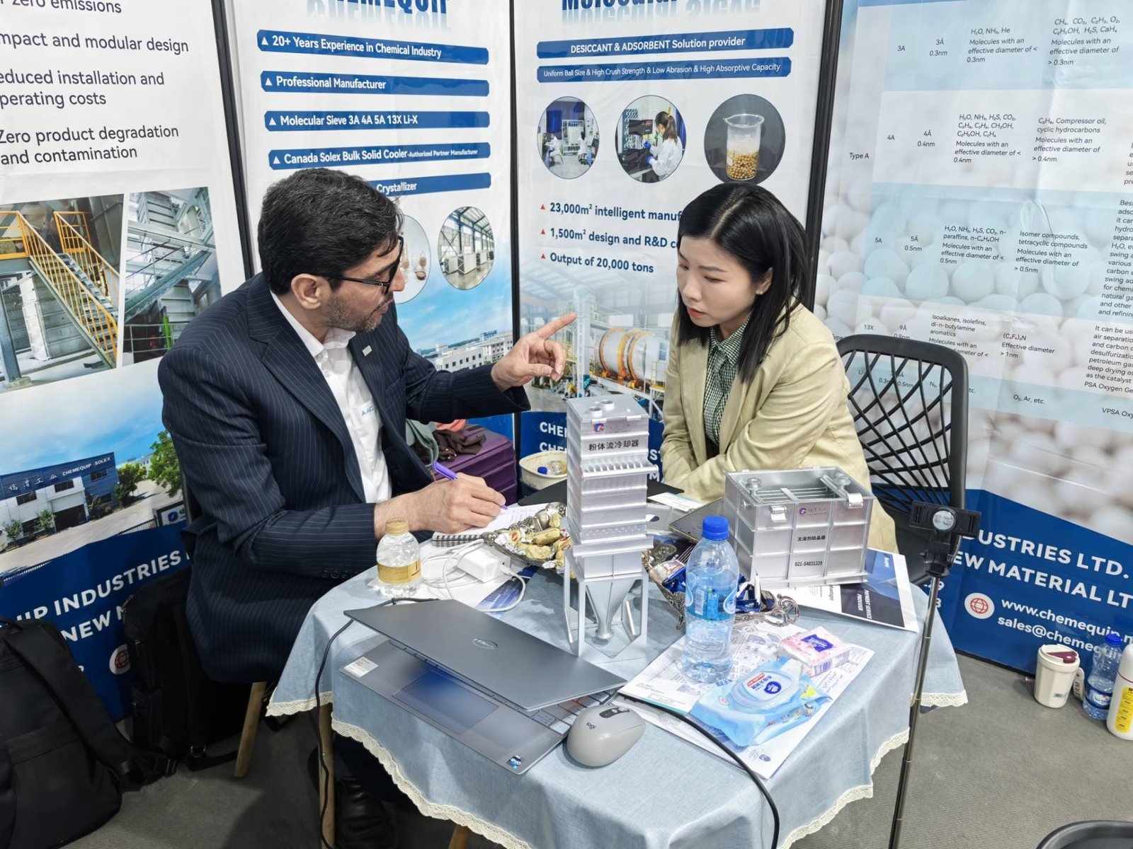 A person inspecting molecular sieve beads in a lab, with a checklist nearby
